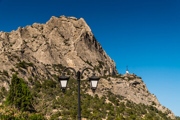 The Republic of Crimea. July 15, 2021. Picturesque view of Sokol Mountain from the embankment in the village of Novy Svet.