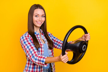 Sticker - Photo of responsible confident lady hold steering wheel prepare trip wear plaid shirt isolated yellow color background