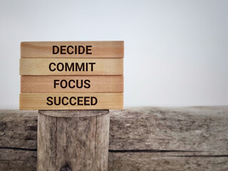 Wall Mural - Inspirational and Motivational Concept - DECIDE COMMIT FOCUS SUCCEED text background. Stock photo.