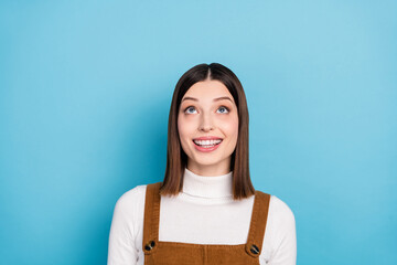 Wall Mural - Photo of young attractive woman wondered look empty space advert isolated over blue color background
