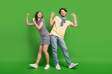 Wall Mural - Full length photo of young excited couple happy positive smile dance party isolated over green color background