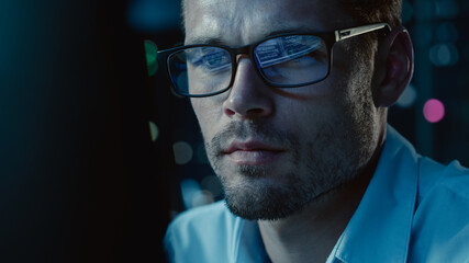 Poster - At Night Portrait of Handsome Startup Digital Entrepreneur Working on Computer, Line of Code Reflecting in Glasses. Developer Working on Innovative e-Commerce App using AI Algorithm Big Data. Blue