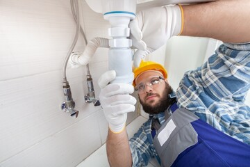 Wall Mural - Man plumber working in the bathroom, plumbing repair service, assemble and install concept.