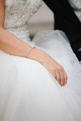 Wall Mural - Wedding bride sit with hand resting on knee in wedding ceremony close up shot