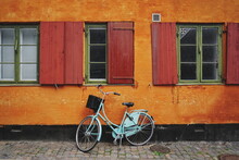 Bicycle On Sidewalk Against Colorful Building