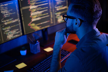 Profile portrait of intelligent minded person hand on chin look two monitors debugging database house loft space