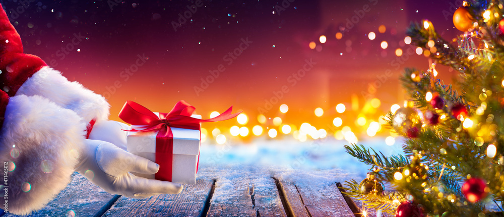 Foto de Stock Santa Claus Putting Gift Present Below Christmas Tree ...