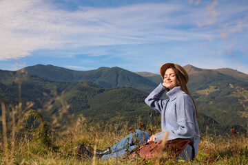 Poster - Young woman enjoying beautiful mountain landscape on sunny day