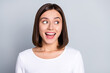 © deagreez - Photo of impressed brunette young lady look empty space wear white shirt isolated on grey color background
