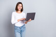 © deagreez - Photo of optimistic bob hairstyle hr lady hold laptop wear white pullover isolated on grey color background