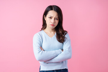 Canvas Print - Portrait of a beautiful young Asian girl, isolated on pink background