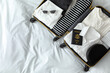 Open suitcase with clothes, passport and accessories on bed, top view. Space for text