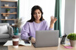 © Prostock-studio - Woman in headphones having videocall using laptop, talking and gesturing