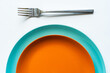 © ADDICTIVE STOCK - Two colored plates placed on each other on white table