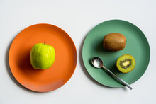 Healthy Green Apple And Kiwi Placed On Ceramic Plates On White Table