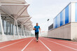 © ADDICTIVE STOCK - Fit man with sportswear and sunglasses running on the field track