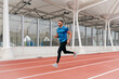 © ADDICTIVE STOCK - Fit man with sportswear and sunglasses running on the field track