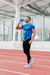© ADDICTIVE STOCK - Athletic man standing and drinking water