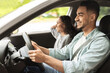 © Prostock-studio - Smiling young middle-eastern man and woman sitting in luxury car