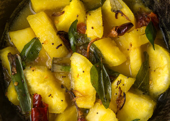 Wall Mural - cassava or manihot dish, also known as manioc, yuca or brazillian arrowroot, prepared with red chilies, curry leaves and mustard seeds, closeup healthy vegetarian cuisine