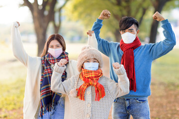 Sticker - Happy family wearing medical mask and walking in the fall park