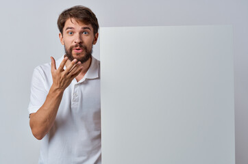 Wall Mural - Cheerful man white paper in the hands of marketing fun Lifestyle isolated background