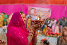Woman Holding An Earthen Lamp In Her Hand With The Faith Of God In Red Saree