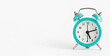 Turquoise alarm clock on white background. Banner, copy space.