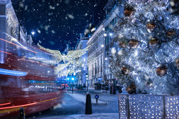 Wall Mural - Conceptional view of London during christmas winter time with blurred street traffic, ice and defocused, falling snow during night time