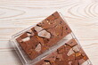 Craft handmade chocolate bars with color splashes on white wooden table. Top view. Copy space.