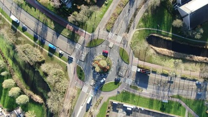 Wall Mural - Top down aerial view of traffic driving over roundabout junction in the Netherlands