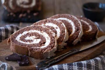 Wall Mural - Delicious chocolate roll cake with white cream, homemade baked dessert