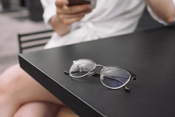 Eyeglasses on a table outside coffee shop