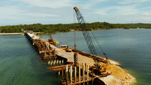 Pile Driving Is Installing Concrete Pile. Heavy Construction Equipment And Workers In The Construction Of A Bridge Across The Strait. Siargao, Philippines