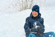 © soleg - a boy plays snowballs outside, beautiful winter weather and white snow around