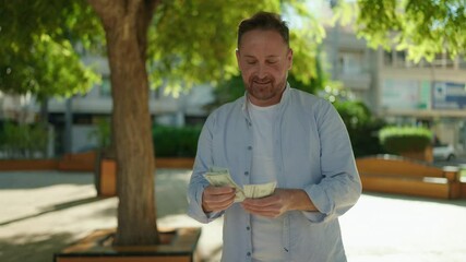 Sticker - Young caucasian man smiling confident counting dollars at park