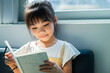 © Timeimage - Asian child reading book at home