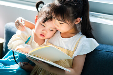 Portrait of two Asian child at home