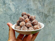Tamarind candy, placed inside white small plate. Sweet and sour candy made from tamarind paste and coated by sugar.