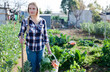 © JackF - Positive girl with a crop of vegetables on a garden bed. High quality photo