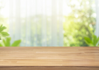 Wall Mural - Selective focus.Empty of wood table top on blur of curtain with window view green from garden