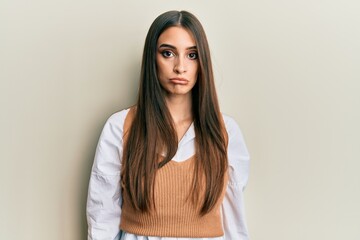 Wall Mural - Beautiful brunette young woman wearing casual clothes depressed and worry for distress, crying angry and afraid. sad expression.