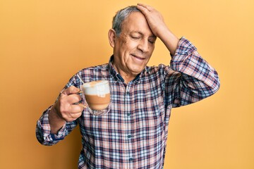 Wall Mural - Handsome senior man with grey hair drinking a cup coffee smiling confident touching hair with hand up gesture, posing attractive and fashionable