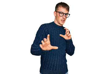 Poster - Young blond man wearing casual clothes and glasses disgusted expression, displeased and fearful doing disgust face because aversion reaction. with hands raised