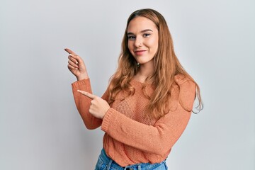 Canvas Print - Young blonde woman wearing casual clothes smiling and looking at the camera pointing with two hands and fingers to the side.