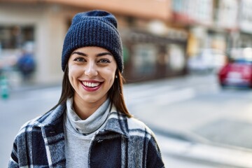 Wall Mural - Young hispanic woman smiling happy standing at the city.