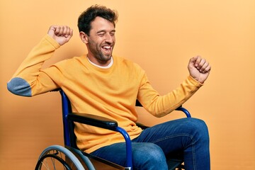 Sticker - Handsome man with beard sitting on wheelchair dancing happy and cheerful, smiling moving casual and confident listening to music