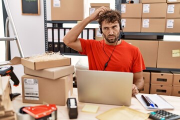 Poster - Young hispanic call center agent man working at warehouse confuse and wondering about question. uncertain with doubt, thinking with hand on head. pensive concept.