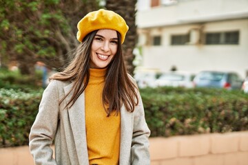 Wall Mural - Young hispanic girl smiling happy standing at the city.