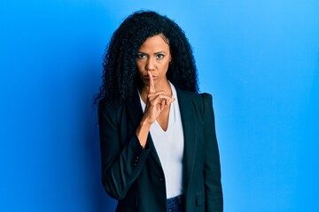 Sticker - Middle age african american woman wearing business clothes asking to be quiet with finger on lips. silence and secret concept.